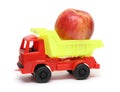 Food transportation concept - toy lorry with apple