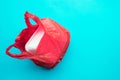 Food trash packing in red plastic bag on blue color background. Recycle and environment concepts