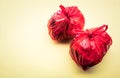 Food trash packing in red plastic bag on color background. Recycle and environment
