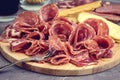 Food Tray With Delicious Salami Pieces of Sliced Ham and Crackers and Bread Sticks Meat Plate Toned Royalty Free Stock Photo