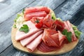 Food tray with delicious salami, pieces of sliced ham, sausage, Royalty Free Stock Photo