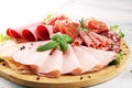 Food tray with delicious salami, pieces of sliced ham, sausage a Royalty Free Stock Photo