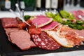 Food tray with delicious salami, pieces of sliced ham, sausage, salad - Meat platter with selection Royalty Free Stock Photo