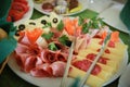 Food tray with delicious salami, pieces of sliced ham, sausage Royalty Free Stock Photo