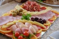 Food tray with delicious salami, pieces of sliced ham, sausage, yellow cheese Royalty Free Stock Photo