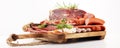 Food tray with delicious salami, pieces of sliced ham, sausages,salad and vegetable. Meat platter with selection Royalty Free Stock Photo