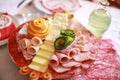 Food tray with delicious salami, pieces of sliced ham and yellow cheese Royalty Free Stock Photo