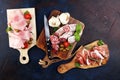 Food tray with delicious salami, pieces of sliced prosciutto crudo, sausage and basil. Meat platter Royalty Free Stock Photo