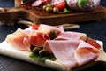 Food tray with delicious salami, pieces of sliced prosciutto crudo, sausage and basil. Meat platter Royalty Free Stock Photo