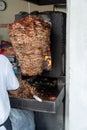 Food Trompo Pastor tacos al pastor, beef stacked in sauce with spices cooked on a taco stove, mexico Royalty Free Stock Photo