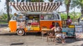 Food truck in a classic orange volkswagen van