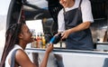 Food truck owner receiving payment from a customer Royalty Free Stock Photo