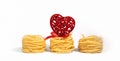 Food for Valentine`s Day. Italian pasta. Spaghetti Capellini, with a creative red heart with a bow, isolated on a white gray Royalty Free Stock Photo