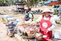 A food vendor in front of Wat Phra That Ing Hang, a relic that Lao and Thai people respect and believe in Savannakhet, Laos