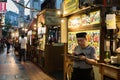 A food vendor studies his mobile phone at Chinatown`s food street as he waits for the evening crowd to arrive, Singapore