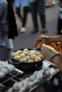 Food vendors making takoyaki, a delicious street food snack at the jogokariyan ramadhan market