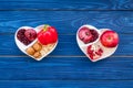 Food which help heart stay healthy. Vegetables, fruits, nuts in heart shaped bowl on blue wooden background top view Royalty Free Stock Photo