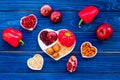 Food which help heart stay healthy. Vegetables, fruits, nuts in heart shaped bowl on blue wooden background top view Royalty Free Stock Photo