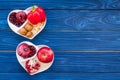 Food which help heart stay healthy. Vegetables, fruits, nuts in heart shaped bowl on blue wooden background top view Royalty Free Stock Photo