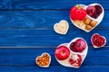 Food which help heart stay healthy. Vegetables, fruits, nuts in heart shaped bowl on blue wooden background top view Royalty Free Stock Photo