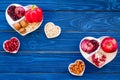 Food which help heart stay healthy. Vegetables, fruits, nuts in heart shaped bowl on blue wooden background top view Royalty Free Stock Photo