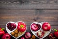 Food which help heart stay healthy. Vegetables, fruits, nuts in heart shaped bowl on dark wooden background top view Royalty Free Stock Photo