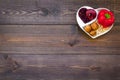 Food which help heart stay healthy. Vegetables, fruits, nuts in heart shaped bowl on dark wooden background top view Royalty Free Stock Photo