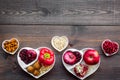 Food which help heart stay healthy. Vegetables, fruits, nuts in heart shaped bowl on dark wooden background top view Royalty Free Stock Photo