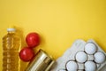 Food on a yellow background, vegetables eggs and oil Royalty Free Stock Photo