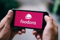 BERLIN, GERMANY - APRIL 14, 2018: Closeup of iPhone screen with FOODORA APP LOGO and ICON