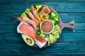Foods containing omega 3. Vitamin Healthy foods: avocados, fish, shrimp, broccoli, flax, nuts, eggs, parsley. Top view. Royalty Free Stock Photo