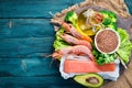 Foods containing omega 3. Vitamin Healthy foods: avocados, fish, shrimp, broccoli, flax, nuts, eggs, parsley. Top view. Royalty Free Stock Photo