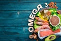 Foods containing omega 3. Vitamin Healthy foods: avocados, fish, shrimp, broccoli, flax, nuts, eggs, parsley. Top view. Royalty Free Stock Photo