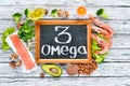 Foods containing omega 3. Vitamin Healthy foods: avocados, fish, shrimp, broccoli, flax, nuts, eggs, parsley. Top view. Royalty Free Stock Photo