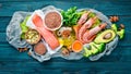 Foods containing omega 3. Vitamin Healthy foods: avocados, fish, shrimp, broccoli, flax, nuts, eggs, parsley. Top view. Royalty Free Stock Photo