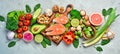 Foods good for the heart: nuts, salmon, avocados, spinach, mushrooms, berries. On a stone background.