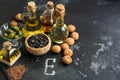 Foods rich in vitamin E on a dark rustic background. Oil, nuts, seeds. Healthy food for rejuvenation. Selective focus, copy space. Royalty Free Stock Photo