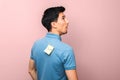 Fool`s day. foolish looking man in blue shirt with a yellow sticky note with word fool on his back stupidly looking up Royalty Free Stock Photo