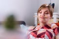 Fooling around at home. Blond bored girl with a trapped pencil between nose and lips Royalty Free Stock Photo