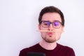 Fooling around at home. Bored young man with a trapped pencil between nose and lips Royalty Free Stock Photo