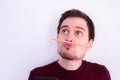 Fooling around at home. Bored young man with a trapped pencil between nose and lips Royalty Free Stock Photo