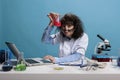 Foolish funny looking crazy chemist having glass flask filled with experimental liquid serum after failed chemical Royalty Free Stock Photo