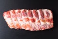 Foos concept organic raw pork ribs on black slate board with copy space Royalty Free Stock Photo