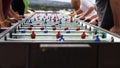 Foosball fanatics. Cropped shot of a group of people playing foosball. Royalty Free Stock Photo