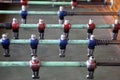 Foosball. Soccer hall game. Traditional game. Soccer game. Table with soccer players. Old wooden foosball. Football players. Dolls Royalty Free Stock Photo