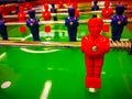 Foosball. Table with red and blue players detail perspective. Royalty Free Stock Photo