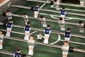 Foosball table or table soccer and players Royalty Free Stock Photo