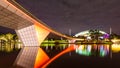 A Foot Bridge crossing a river and Sports Stadium at Night