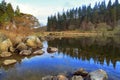 Foot bridge and pine trees reflected in Llyn Mymbyr Capel Curig Snowdonia