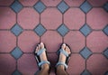 Foot on cement brick block walk path from above